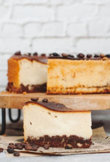 a slice of cofee cheesecake on a wood board
