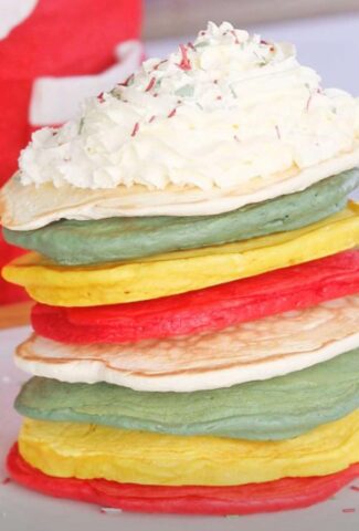 a stack of Festive pancakes with whipped cream on top