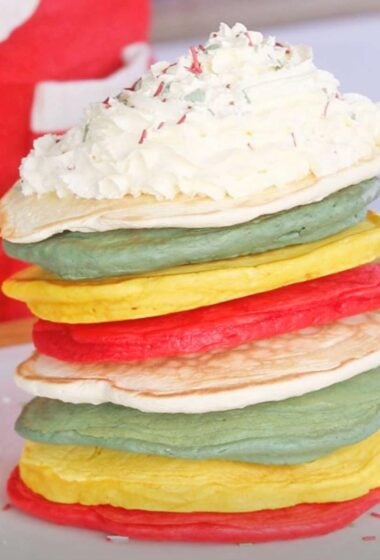 a stack of Festive pancakes with whipped cream on top