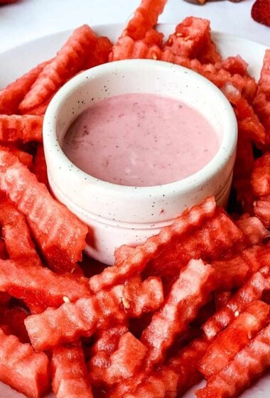 a white plate of Fruity Watermelon fries with a dip
