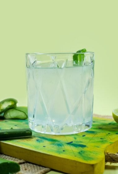 a glass of Aloe Vera Juice on a cutting board