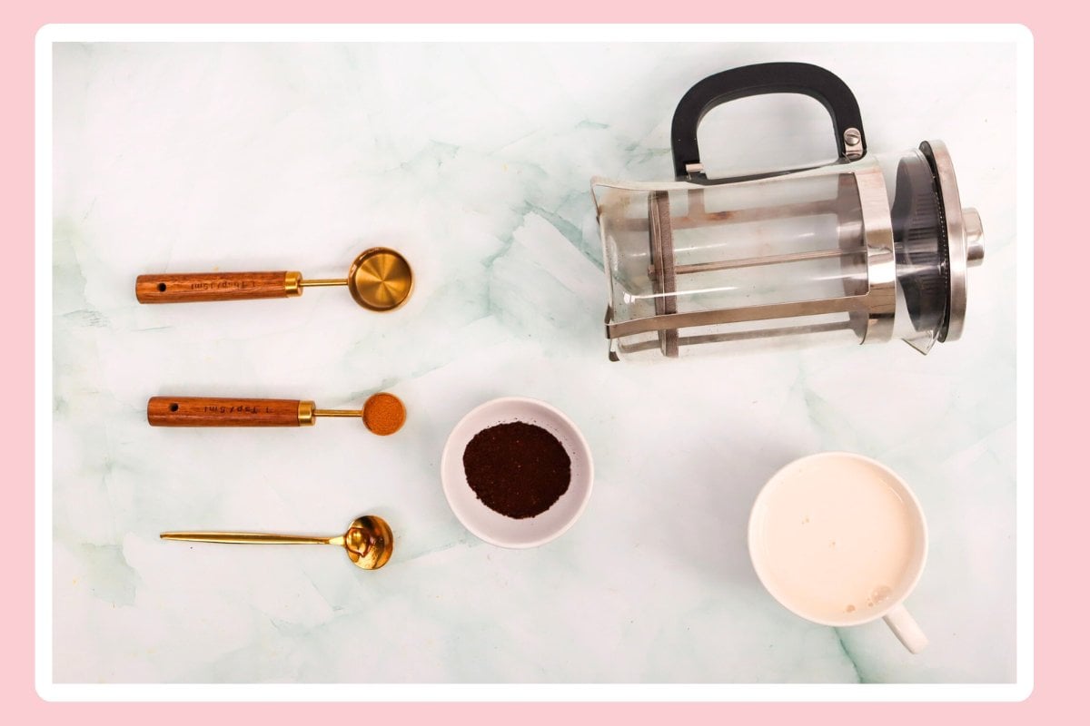 a flat lay of ingredients and tools for making a Starbucks-inspired Iced Cinnamon Dolce Latte
